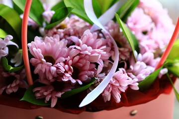 Poster - A bouquet of pink flowers surrounded by green leaves.
