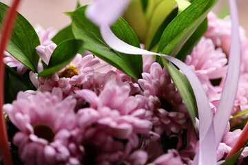 Poster - A close-up view of a bouquet of colorful flowers arranged in a wicker basket.