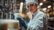 © olvius - A worker at a modern dairy takes a milk sample from a large container for quality control analysis. Organic food concept. Healthy products