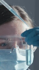 Aufkleber - In a busy hightech lab, a dedicated scientist in protective gear examines a test tube of vibrant blue liquid, representing the rigorous nature and advancements in science and medicine