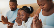© BuyOutFelix01/peopleimages.com - Worship, relax and prayer with black family in bed for trust, spiritual morning and bonding. Support, God and christian faith with parents and children at home for religion, gratitude and catholic