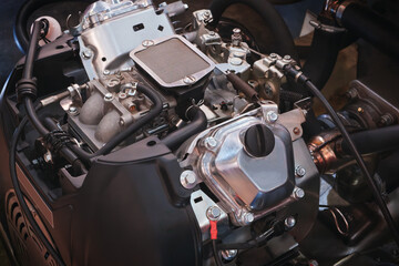 Aufkleber - A close up of a car engine with a black and silver color scheme. The engine is the main focus of the image, and it is a powerful and well-built piece of machinery