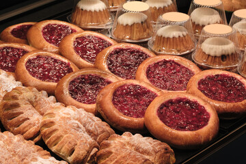 Poster - A display of pastries with a variety of flavors and textures. The pastries are arranged in a way that highlights their differences and invites the viewer to try them. Scene is one of indulgence
