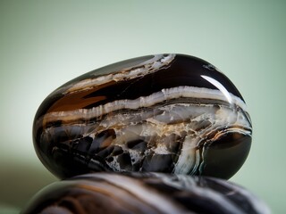 Poster - Onyx Stone Close-up. Polished Black Gemstone With Swirling White Veins, A Study In Contrasts. Texture, Beauty, And Geological Wonder Captured In High Detail. A Captivating Image.