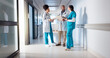 © peopleimages.com - Hospital, discussion and doctors in hallway talking for consulting, patient results and planning. Healthcare, collaboration and men and women with notes for medical service, diagnosis and help