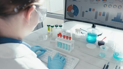 Aufkleber - A dedicated scientist in a laboratory setting works meticulously with test tubes and monitors data analysis on a computer screen, reflecting advanced scientific research in medicine.
