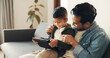 © peopleimages.com - Home, smile and father with child for tablet, streaming movies and bonding together with technology. Couch, dad and love with boy for digital video, cartoon and watch film on website in living room