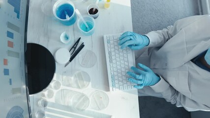 Aufkleber - A dedicated scientist in a lab coat and gloves types on a computer, surrounded by lab equipment like petri dishes and solutions, analyzing complex data on a monitor for research and experiments