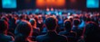 © Rick Cranches - Blurred audience at a professional business conference in a large hall.