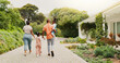 © BuyOutFelix01/peopleimages.com - Outdoor, black family and parents with children for walking, connection and bonding together by house. Back, mom and dad with kids for holding hands, carrying and relationship on weekend in property