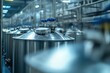 © At My Hat - Shiny metal tanks with blue valves in a factory or brewery setting. Illustrates brewing, industrial processes, or manufacturing concepts.