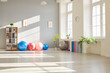 © Studio Romantic - Interior of empty fitness gymnasium for yoga classes with sport equipment of fit balls and mats on the floor. Panoramic view of rehabilitation gym in medical clinic for physical treatment.