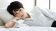 © Candice - Photo of a Young Woman Resting on a White Bed Daytime Serenity
