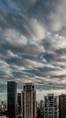 Poster - Timelapse of dramatic clouds over city skyline at dusk