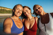 © (JLco) Julia Amaral - Three mature friends taking a selfie on a sunny beach day