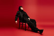 © Bliss - Urban vogue asian man exudes confidence in studio against a vivid red backdrop