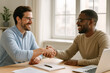 © romanets_v - Caucasian and african adult males shaking hands in bright office environment