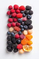 Poster - Top-view flat lay photography of mixed dried berries and tropical fruits in colorful piles, placed