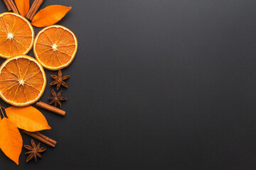 Poster - Artistic arrangement of dried orange slices, cinnamon sticks, and star anise on a dark slate