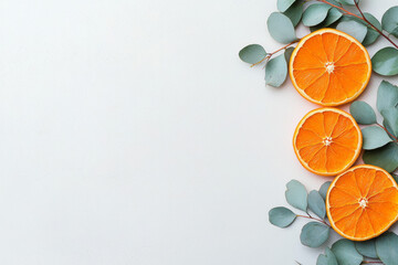 Poster - Bright stock photo showcasing dried orange slices displayed artistically among eucalyptus leaves on