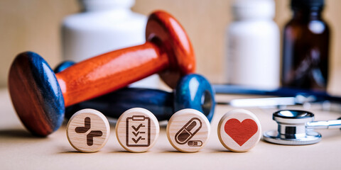 Aufkleber - Wooden discs with health icons; cross, checklist, pill, heart; near dumbbells and stethoscope, symbolizing wellness, healthcare, and healthy lifestyle choices