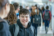 © Natallia - Smiling autistic teenager in busy school hallway