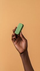 Poster - Minimalist Tech Innovation Hispanic Professional Showcasing Sustainable Green Tracking Device in Clean, Warm-Toned Industrial Design Mockup