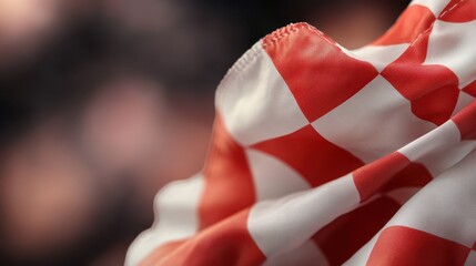 Poster - A striking close-up of a red and white checker flag flowing elegantly, showcasing the vibrant colors and smooth fabric, capturing motion and energy in the moment.
