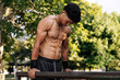 © kleberpicui - Strong young sportsman doing calisthenics at outdoor gym
