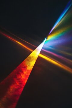 Rainbow-like light beams on a black background, phone wallpaper
