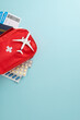 © ActionGP - Essential travel healthcare preparation featuring a red first aid kit, blister packs, patient cards, and a travel-themed vertical airplane model, perfect for safe exploration