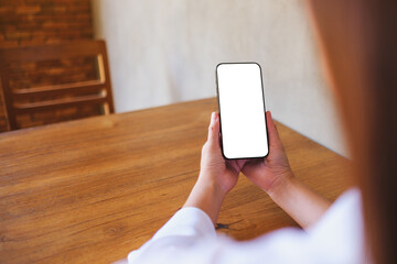 Wall Mural - mockup image of a woman holding black mobile phone with blank desktop screen
