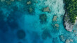 © Oksana - Aerial shot of a crystal-clear ocean lagoon, shallow turquoise waters revealing vibrant coral reefs