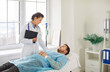 © Studio Romantic - Young female nurse or woman doctor supporting and giving consultation to male sick patient lying on couch in medical clinic receiving IV drip infusion and vitamin injection therapy. Medicine concept.