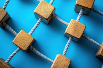 Poster - several wooden cubes linked together on a vibrant blue background, symbolizing unity and cooperation
