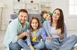 © Studio Romantic - Happy family joy at home together, parents, cute kids portrait having joy sitting together on warm floor, cheerful couple laughing playing with little active children son, daughter in living room