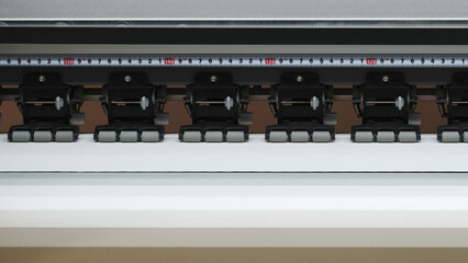 Poster - A printer with a ruler on it. The ruler is black and white and has numbers on it