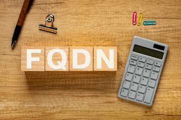 Poster - There is wood block with the word FQDN. It is an abbreviation for Fully Qualified Domain Name as eye-catching image.