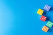 © Daria - Colorful cube shaped checkmark on blue background  business plan concept with copy space