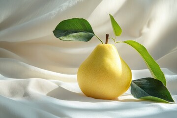 Fototapete - Fresh yellow pear rests elegantly on soft white fabric, showcasing natural beauty in morning light with delicate green leaves enhancing its charm
