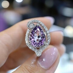 Poster - woman delicately holding a beautiful featuring a striking purple stone in a close-up shot