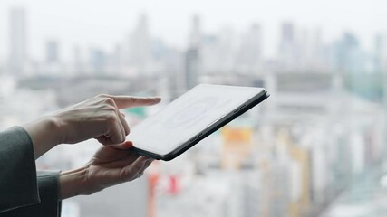 Poster - A woman using a tablet PC with a city in the background