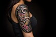 © Thammarong - A woman with a full-sleeve tattoo, featuring Japanese koi fish, cherry blossoms, and waves