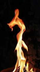 Poster - Dynamic flames dance: mesmerizing fire motion on dark background in ultra hd