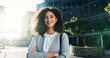 © peopleimages.com - Portrait, smile and woman with arms crossed, city and commuting to work in morning, social worker and road. Outdoor, human services professional and happy person on urban street, travel and employee