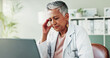 © peopleimages.com - Therapist, headache and mature woman with stress, pain and tired in clinic. Migraine, medical professional and massage temples for depression, mental health and sick for burnout by laptop in office