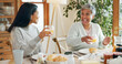 © peopleimages.com - Breakfast, drink and smile with family at home for bonding, nutrition and food. Morning, wellness and health with senior mother and daughter in dining room of house for connection, support or brunch