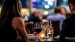 © Arliyan - A couple enjoys a romantic dinner with wine in a softly lit restaurant.