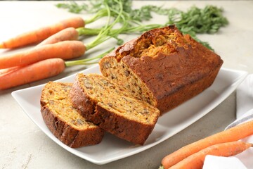 Wall Mural - Homemade carrot cake with nuts and vegetables on light grey table, closeup