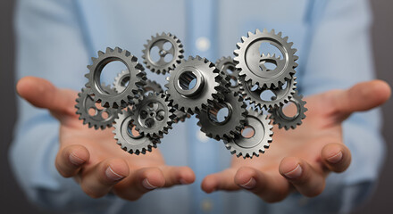 Poster - Hands Presenting Silver Cogwheels Representing Technological Advancement and Industrial Precision in Blue Background